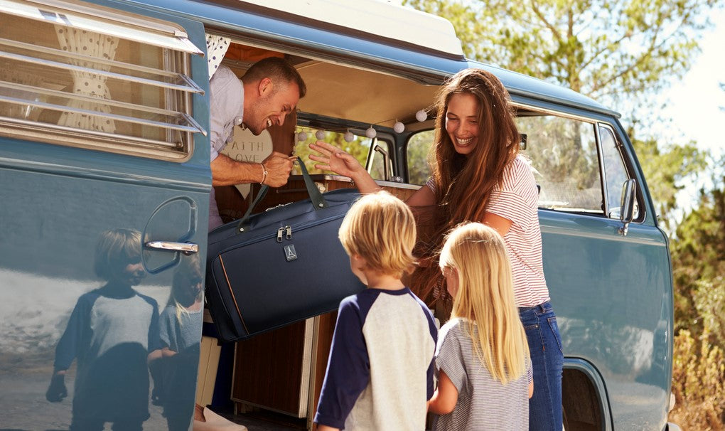 Family holding crew versapack weekender duffel in van