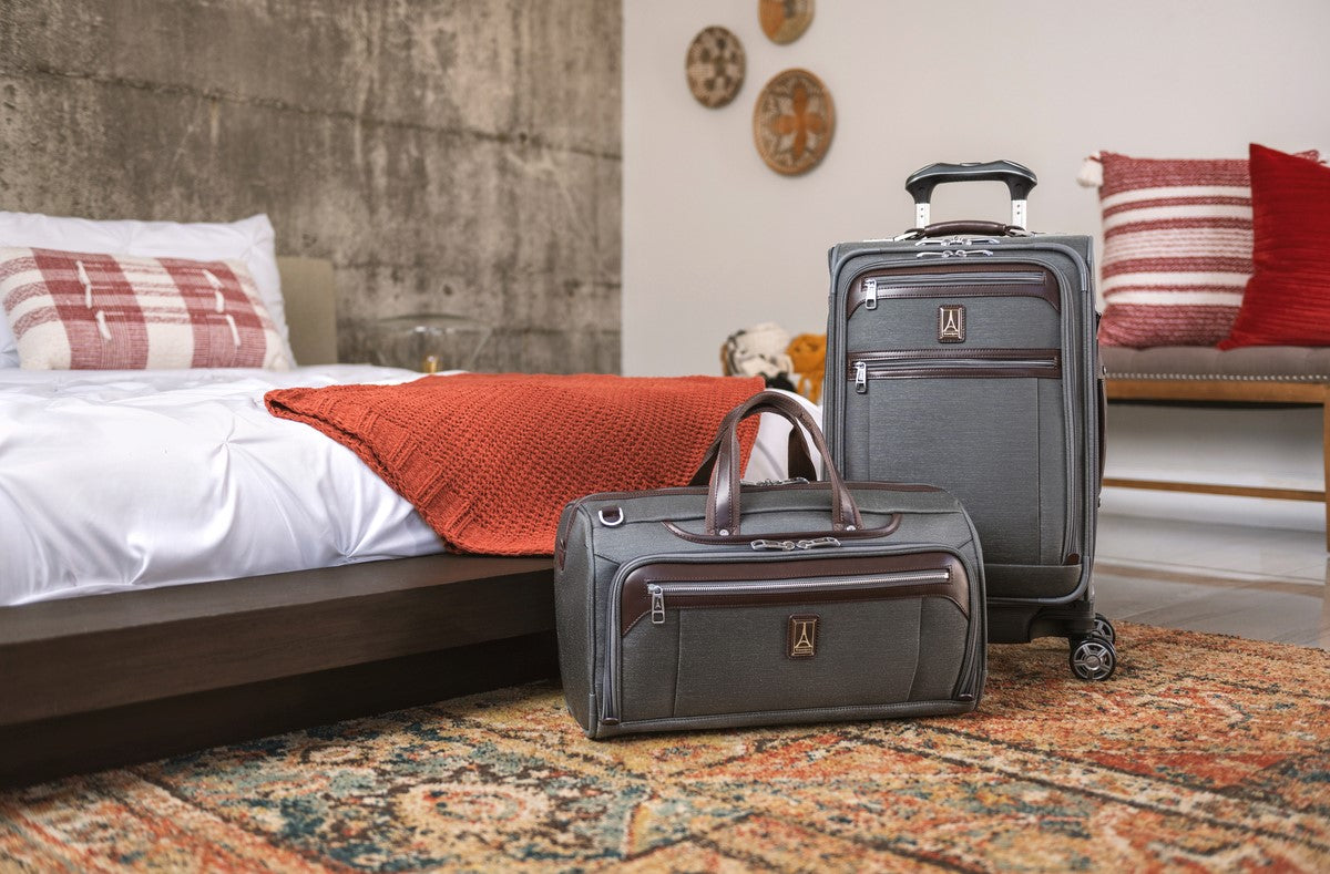 Platinum Elite Carry son spinner and carry on regional duffel sitting next to bed in bedroom